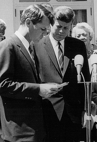 
                    President John F. Kennedy listens as his brother Robert speak at a White House ceremony, May 7, 1963.
                                            (National Archive/Newsmakers)
                                        