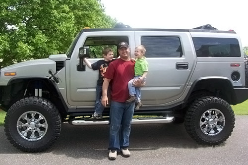 
                    Dave Harmon standing in front of the Hummer H2 he desperately wishes to sell. With him are his children Ashton, age 4, and 2-year-old Brody.
                                            (Courtesy Dave Harmon)
                                        