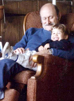 
                    Mark Kaufman's father holding Josh, the only grandson he met before he passed away. Kaufman took this photo just before his father passed away at age 65. At the time the photo was taken, he was listening to some jazz cassettes that his son made for him, and listened primarily to jazz.
                                            (Mark Kaufman)
                                        