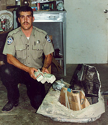 
                    Barry Cooper, before: making a bust as a narcotics cop. "I thought I had the greatest job in the world -- I was the young hot shot narcotics cop," he says. "It was thrilling for a young man being thrown in that game."
                                            (Courtesy Barry Cooper)
                                        