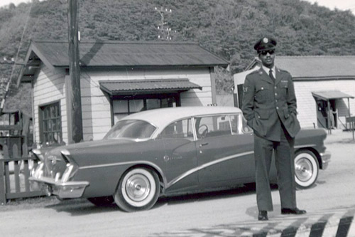 
                    Willie Cooper, Sr., standing in front of his Buick. Cooper always wore his uniform whenever he drove the family on cross-country road trips, hoping it would insulate them from racial discrimination if people knew he was serving his country. The tactic didn't always work.
                                            (Courtesy Desiree Cooper)
                                        