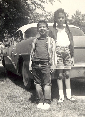 
                    Desiree and her brother Bill standing beside "Old Betsy," the 1954 Buick Special that carried them on countless cross-country road trips with Dad at the wheel.
                                            (Courtesy Desiree Cooper)
                                        