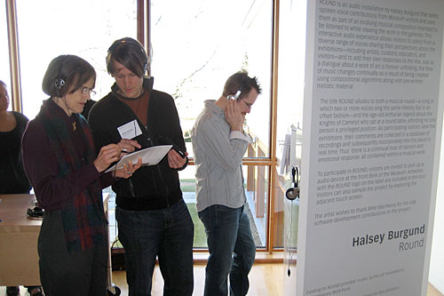 
                    Halsey Burgund (center) explains his interactive art project to a museum patron.
                                            (Courtesy Halsey Burgund)
                                        