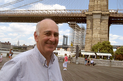 
                    Weekend America guest and writer Phillip Lopate standing in front of the scaffolding for the Brooklyn Bridge waterfall.
                                            (Sally Herships)
                                        