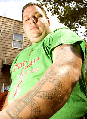 
                    Joe Speruta has been a Giglio lifter for  17  years. On his arm he has a tattoo of the Giglio surrounded by the notes to the Giglio song, "Giglio Paradiso."
                                            (Michael Bocchieri)
                                        