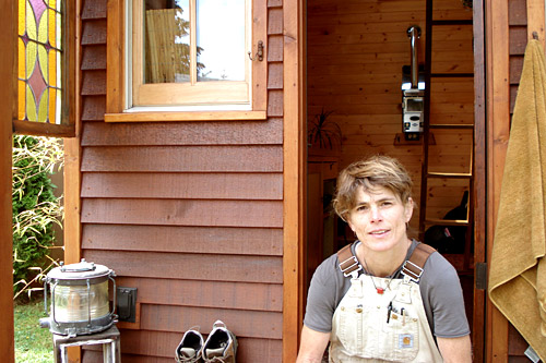 
                    Dee built her house by hand using salvaged wood from construction sites, dumpsters or building salvage supply stores.
                                            (Joshua McNichols)
                                        