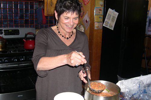 
                    Jeannette Ferrary ladles up the "wolf" that she just cooked, that is, Gaspacho soup.
                                            (Krissy Clark)
                                        