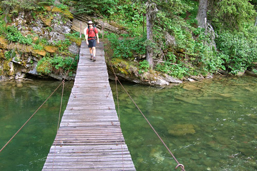 
                    Weekend America correspondent Michael May crosses the Belly River in Glacier National Park on a suspension bridge.
                                            (Rachel Proctor May)
                                        