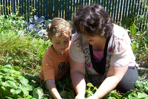 
                    Debra Nicholls and her son Conner during a home-school lesson.  Debra says, "This summer, much of our learning happens outside, in the garden."
                                            (Courtesy Debra Nicholls)
                                        
