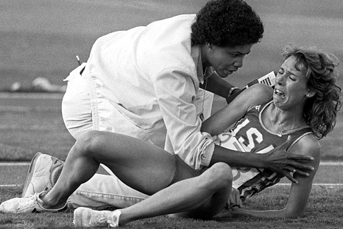 
                    U.S. runner Mary Decker is comforted by a track official after falling during the women's 3000m final at the Los Angeles Olympic games in August, 1984.
                                            (Staff/AFP/Getty Images)
                                        