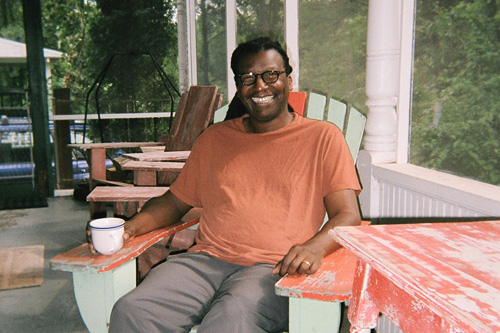 
                    Cornelius Eady unwinds one recent weekend on the big house's porch.
                                            (Sarah Micklem)
                                        