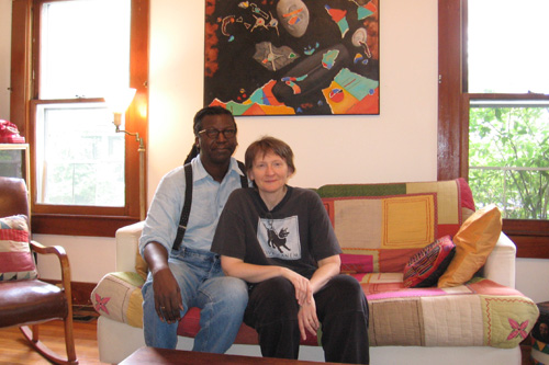 
                    Cornelius Eady and Sarah Micklem sit on the infamous white couch. Eady wrote a poem about it in his new collection "Hardheaded Weather."
                                            (Marie Eady)
                                        