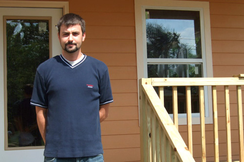 
                    Brian Rivers, East Biloxi Hope Coordination Center, in front of Betty Davis' new home.
                                            (Michael May)
                                        