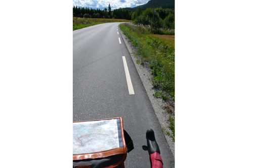 
                    Pretty much our constant view from the handlebars. Bicycle tourism puts you in the landscape, and the world goes by at just the right speed for observation.
                                            (Leif Larsen)
                                        