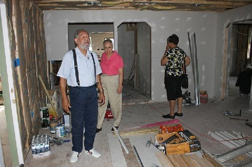 
                    This is inside the home of Katrina survivor Edwin Harrison. He hopes to move back in within the month. The house is in New Orleans' 7th Ward. Along with Mr. Harrison are Sandra Peters in the pink shirt and Jaci Sturgies. Both are from Charlotte, North Carolina and were in town for the 30th Cooper Family Reunion.
                                            (Curt Peters)
                                        