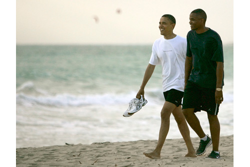 
                    Sen. Barack Obama, D-Ill., walks down Kailua Beach in August with Marty Nesbitt, his friend and campaign treasurer. "It was actually a bit of a cloudy day, rays of sun shooting through the clouds on the water," photographer Mike Burley recalls. "Most people left him alone, and he continued walking along the beach. He had this look of relaxation on his face, he looked very happy to take a vacation."
                                            (Mike Burley, The Honolulu Star-Bulletin)
                                        