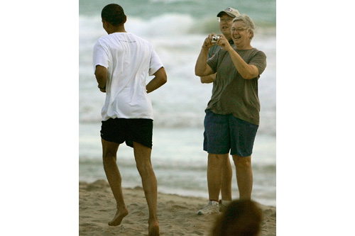 
                    Dianne Cook of Kailua snapped photographs of Democratic presidential hopeful Sen. Barack Obama as he took a morning jog on Kailua Beach.  "It took me by surprise that he was able to blend in, and a lot of people jogged right past him without even knowing it," Burley says.
                                            (Mike Burley, The Honolulu Star-Bulletin)
                                        