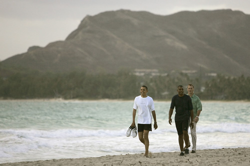 
                    Burley recalls Obama's expression, "He just looked really relaxed and just glad to be off the campaign trail...  To me, it just looked like a guy without a care in the world taking in the beauty of Hawaii."  The third man in the photo in the green shirt is with the Secret Service.
                                            (Mike Burley, The Honolulu Star-Bulletin)
                                        