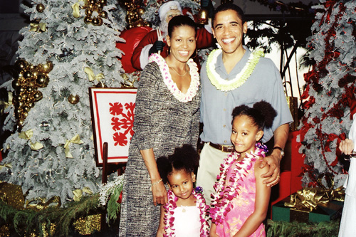 
                    Obama with his wife Michelle and two daughters, Malia and Sasha, in front of the Christmas trees at the Hilton Hawaiian Village in Honolulu Dec., 2004. Obama was speaking at an event held in his honor called, "A Night of Aloha with Senator Barack Obama," which was also a fundraiser for the Democratic Party of Hawaii.
                                            (Gig Greenwood)
                                        