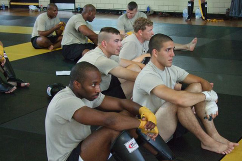 
                    Soldiers sit on the mat at the U.S. Army Combatives training school.
                                            (Philip L. Graitcer)
                                        