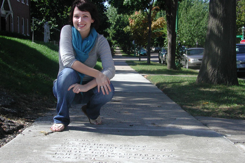 
                    Caley Conney with her finished poem "Bad day," newly impressed onto the sidewalk.
                                            (Chris Roberts)
                                        