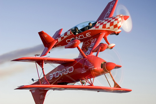 
                    Sean and Eric Tucker, father and son, perform together as part of a formation team. "When Eric and I are in the sky together flying, he's not my son, he's my peer," says Sean Tucker.  Sean Tucker is in the inverted biplane, Eric Tucker is in the background.
                                            (www.jessicaambats.com)
                                        