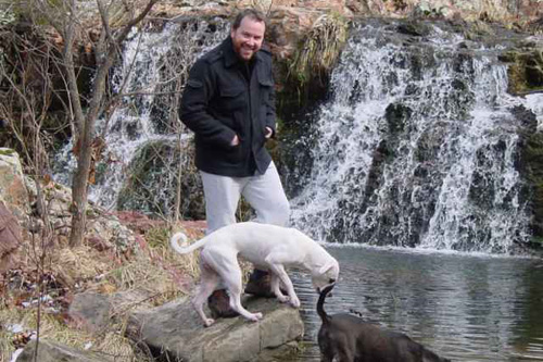 
                    Kevin Bunten with his dogs, hiking on his property in rural Missouri.
                                            (Courtesy Kevin Bunten)
                                        
