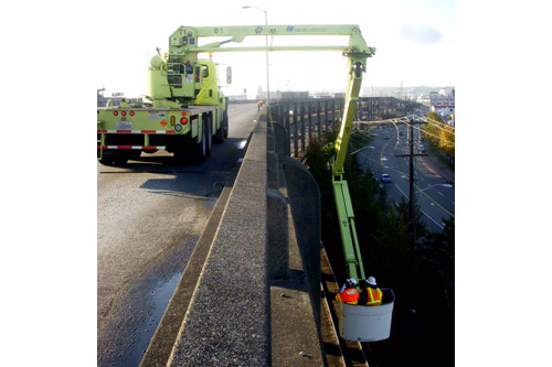
                    Crews use a crane to inspect erosion on the Alaskan Way Viaduct.
                                            (Jim Gates)
                                        