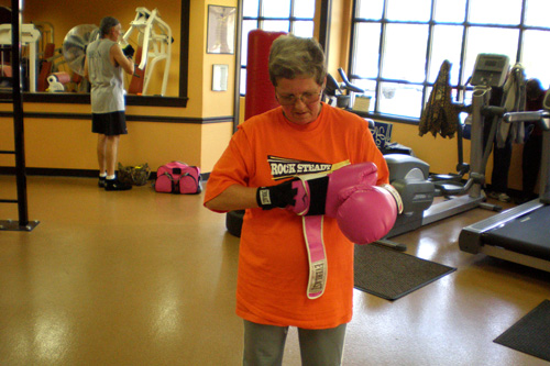 
                    Mary Yeman, 60, puts on her pink boxing gloves at Rocky Steady Gym in Indianapolis, Ind.
                                            (Colleen Iudice)
                                        