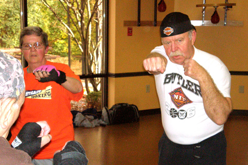 
                    Mary Yeman and Don Schafer warm up for their boxing class. Both were diagnosed with Parkinson's a few years ago.
                                            (Colleen Iudice)
                                        