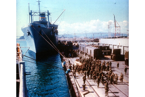 
                    American troops await their turn to board the troopship General Nelson M. Walker at the Naval Supply Station, Oakland, California, sometime in 1966. The Walker was over 600 feet long and could carry as many as 5,000 troops during each of her voyages. It took from 18 to 21 days to reach Vietnam.
                                            (Courtesy Naval Supply Station)
                                        