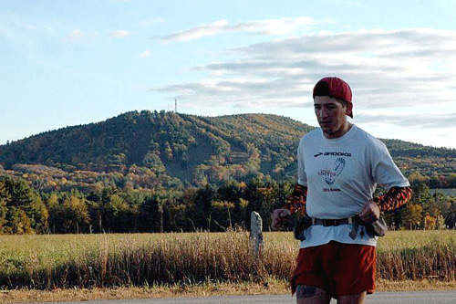 
                    John Lacroix is running across the state of New Hampshire with his friend Nate Sanel. If one runner feels particularly good or bad, they'll separate and reconnect up the road. Here, John goes off on his own for a stretch.
                                            (Sarah Chretien)
                                        