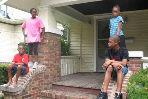 
                    The Gilbert children outside their old house in Bloomington Illinois.  This weekend, they're moving four miles north to Normal. Clockwise from top left:  Imani, age 11; Ayanna, age 7; Mark Jr., age 12, Nia, age 9.
                                            (Laurie Stern)
                                        
