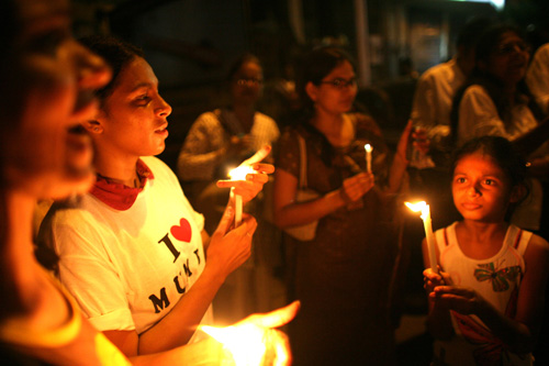 
                    Indians light candles as thousands of Mumbaikars take part in a mass demonstration march following last weeks' series of terrorist attacks on the city.
                                            (Uriel Sinai/Getty Images)
                                        