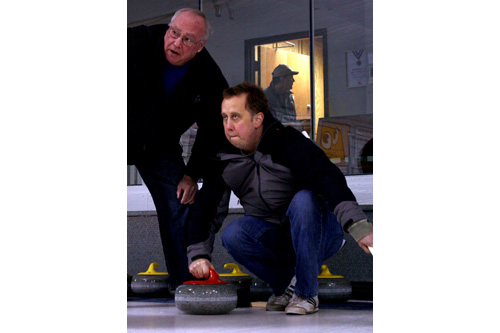 
                    John Moe gets some tips from Jim "Dex" Dexter on stone throwing technique at the St. Paul Curling Club.
                                            (Marc Sanchez)
                                        