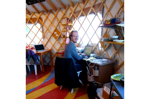 
                    Bretwood "Hig" Higman works inside the yurt.
                                            (Erin McKittrick)
                                        