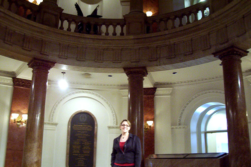 
                    Jeanette Garcia, Chief of Correspondence to Baltimore Mayor Sheila Dixon, stands under the City Hall rotunda. When the Mayor of Vilnius sent a letter to Mayor Dixon offering the city a bronze bust of Frank Zappa, it couldn't have landed in better hands. Garcia is a huge Zappa fan. One of her favorite pieces of Zappa's music is the "Dog Breath Variations."
                                            (Lawrence Lanahan)
                                        