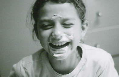 
                    At the sleepover, Mimi pushes her face in a piece of cake.
                                            (Maureen Wellner)
                                        