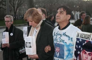 
                    Cindy Sheehan in front of the white house reading the names of fallen soldiers.
                                            (Michael May)
                                        
