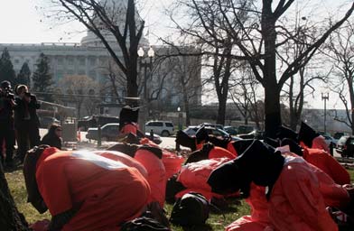 
                    Protesters dressed as Guantanamo prisoners.
                                            (Michael May)
                                        