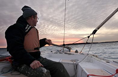 
                    On a test sail before his final departure BJ glances back at the fading sunset.
                                            (Amanda Kowalski)
                                        