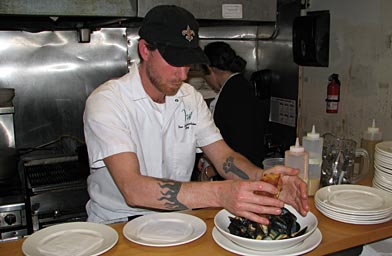 
                    Chef Ian Schnoebelen, working in the kitchen of his restaurant, Iris, in his Saints hat, of course.
                                            (Keith O'Brien)
                                        