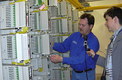 
                    Dan Olsen shows off Windom's fiber to home system. Each fiber optic cable can transfer vast amounts of information but is only the width of a human hair.
                                            (Molly Bloom)
                                        