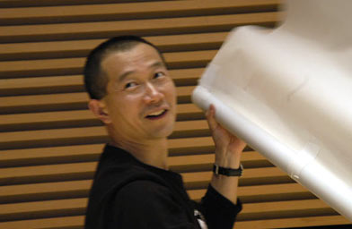 
                    Tan Dun with a paper instrument.
                                            (Fort Worth Symphony Orchestra)
                                        