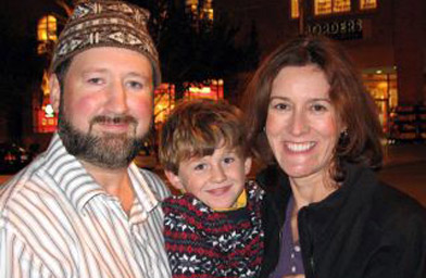 
                    The snapshot of this young American family on Broadway in Saratoga Springs was the first glimpse Fair Isle got of its newest residents. Henry's knit sweater drew a nod of approval from the community of knitters on the Isle. Tommy is wearing one of the hats that he makes.
                                            (Tommy Hyndman)
                                        