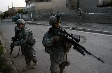 
                    U.S. soldiers from Baker Company 2-12 Infantry Battalion patrol through the streets of the Dora neighbourhood of southern Baghdad, March 16, 2007.
                                            (David Furst / Getty Images)
                                        