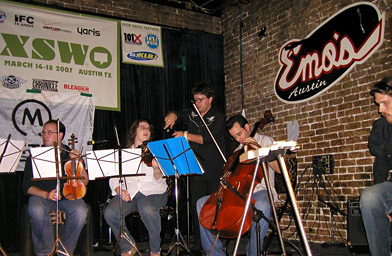 
                    Emo's sound guy Joshua Case setting up a string quartet during the SXSW festival.
                                            (Alex Cohen)
                                        