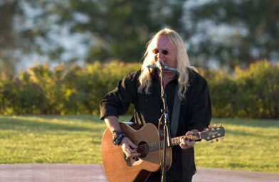 
                    John Fiddler performs with his guitar and harmonica.
                                            (John Fiddler)
                                        