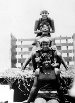 
                    Top to Bottom: Susie Thorton, Grace Williams, Mary Mingleton, Grace Harris on back of truck on hayride to Manhattan Beach (Bruce Beach), circa 1925.
                                            (Los Angeles Public Library)
                                        