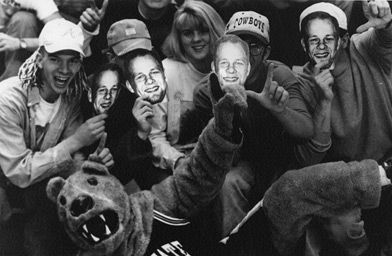 
                    "Nate Althouse Fever" grabbed hold of a number of Penn State basketball fans in the mid-90's. Here, a handful of supporters don homemade "Nate Masks;" a blown up photo taped to a Popsicle stick.
                                            (The Daily Collegian)
                                        
